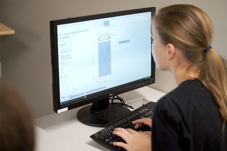 A student works at a computer.